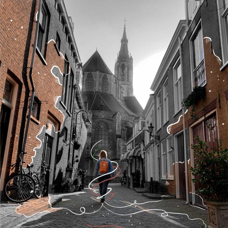 Wendy walking towards a church in a street. The buildings are all partially grey, except for the ones she walked past: those have gained color. There are lines running from the walls to Wendy.